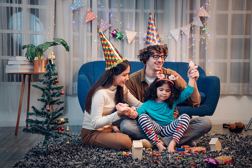 Happy  lovely family father, mother and children celebrate Christmas and new year, light sparklers.