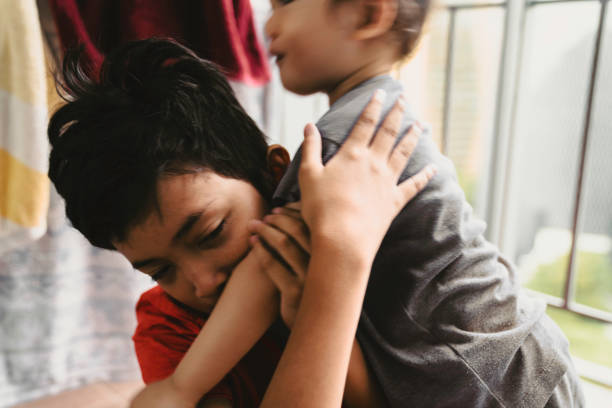 istock toddler hug his big brother 1437588963