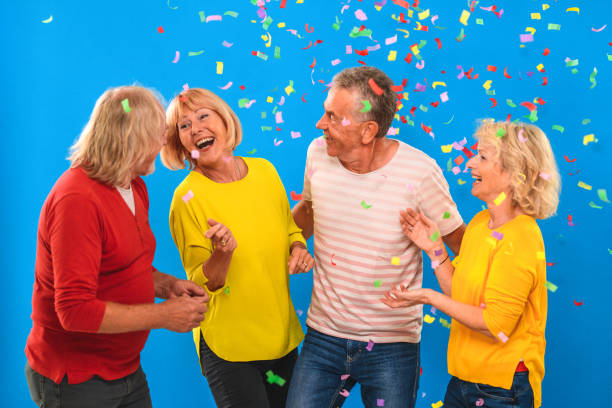 istock Cheerful Senior Friends Clapping and Dancing at a Birthday Party 1437596076