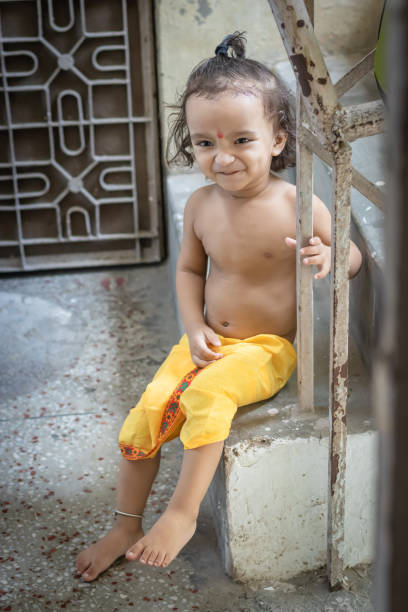 istock baby boy cute facial expression in krishna dressed from unique perspective 1437608390