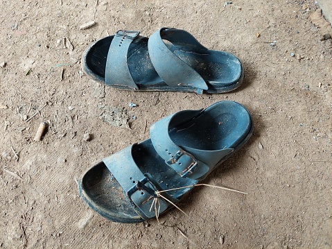 Used sandals lie on the ground