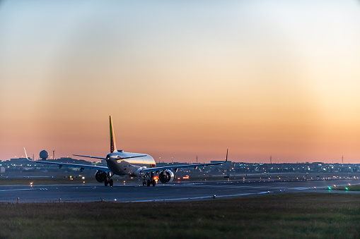 An airplane of Air Portugal taxiing on runway in Pearson International airport at dusk, Toronto,Canada.