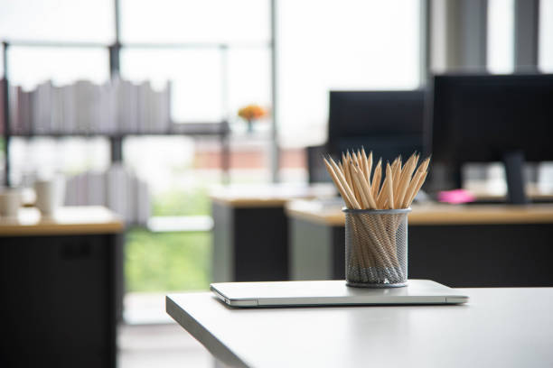 istock Pencils in grey office cup on the white desk in business office 1437612809