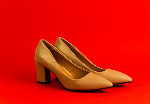 A high heel studio shot for object with red background