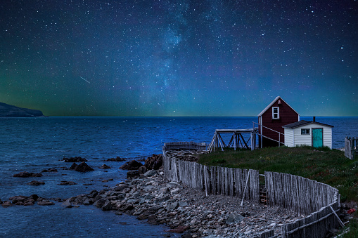 A small home admires the stars as it looks out over the Atlantic Ocean at the shore of Bonavista, Newfoundland.