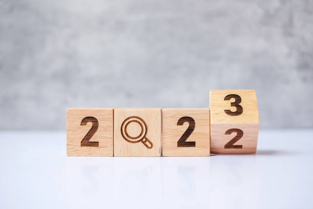 istock flip 2022 to 2023 block with magnifying glass icon. SEO, Search Engine Optimization, hiring, Advertising, Idea, Strategy, marketing, Keyword, Content and New Year start concepts 1437617690