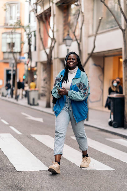 istock Happy African Girl Using Phone 1437622956