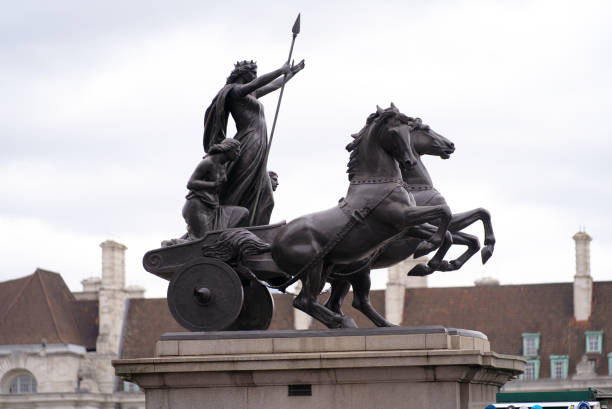 Sculpture of women with horse wagon at English town. Bronze memorial of Boudica with her daughters at City of Westminster on a cloudy summer day. Photo taken August 3rd, 2022, London, United Kingdom. boadicea statue stock pictures, royalty-free photos & images