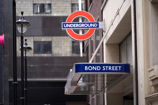 Sign at entrance of underground station Bond Street at City of London on a cloudy summer day. Photo taken August 3rd, 2022, London, United Kingdom.
