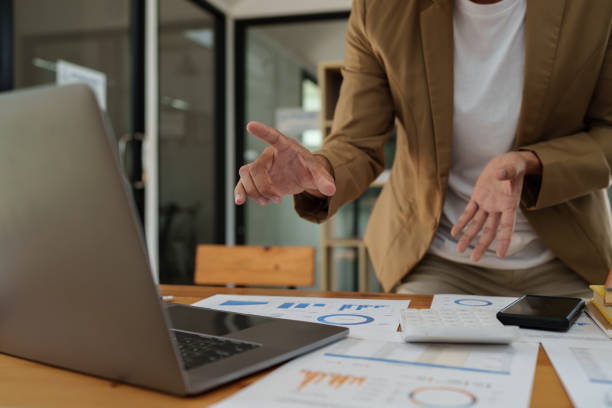 istock Asian businessman checking information while working with satisfaction on his laptop. 1437627059