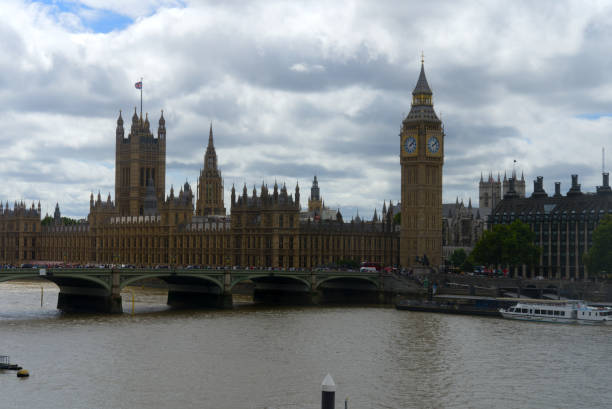 istock Clock tower with clock face and Big Ben clock at English town. 1437628168
