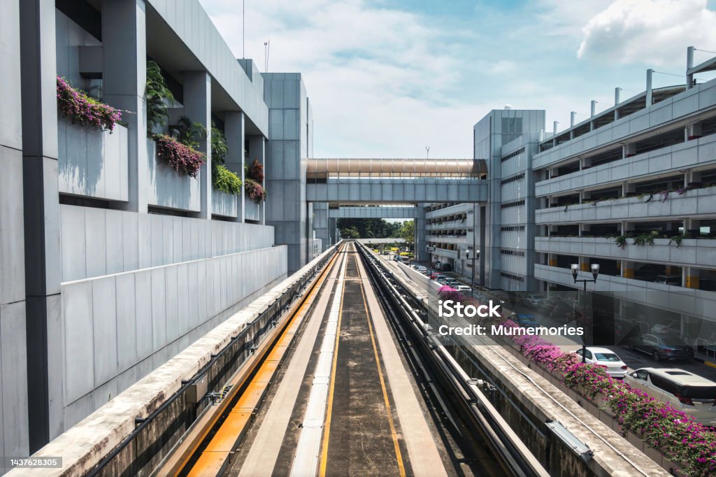 Electric skytrain airport link for passenger arrival to the next airport with running through the outside and parking building POV view of Electric skytrain airport link for passenger arrival to the next airport with running through the outside and parking building Advertisement Stock Photo