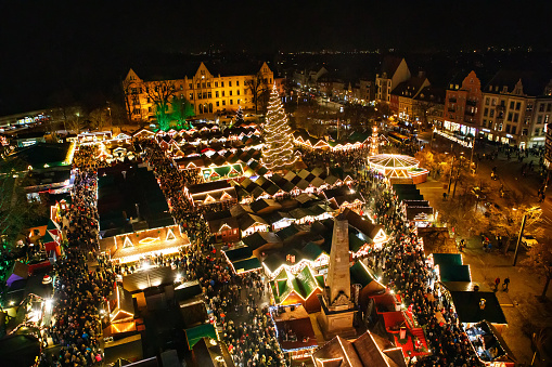 Traditional Christmas market in Erfurt, Thuringia in Germany. With xmas tree, pyramide and sales and food stands on late evening or night
