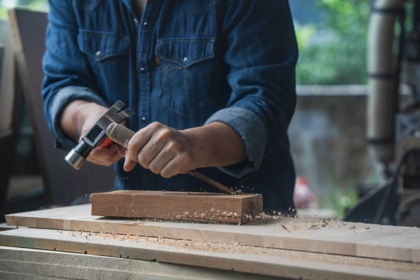 istock gouge wood chisel carpenter tool hammer in hand working wooden background 1437632386
