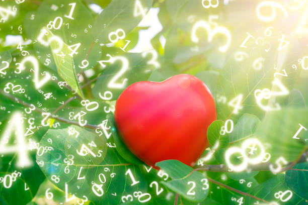 numerology, red heart between the green leaves of the bush, in the rays of the sun, surrounded by numbers numerology, red heart between the green leaves of the bush, in the rays of the sun, surrounded by numbers kurma stock pictures, royalty-free photos & images