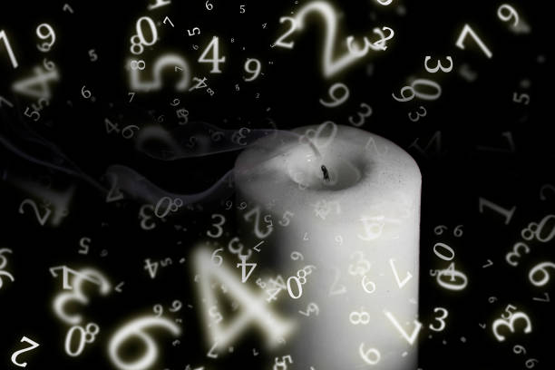 istock numerology, an extinguished candle with smoke in the dark, surrounded by numbers 1437632515