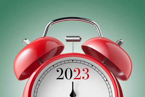New Year 2023. Close up view of a red alarm clock.