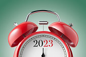 istock New Year 2023. Close up view of a red alarm clock. 1437633511