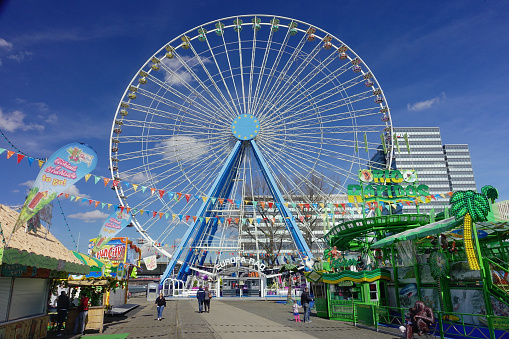 Cologne, Germany – March 31, 2018: ferris wheel on a funfair on a bright sunny day