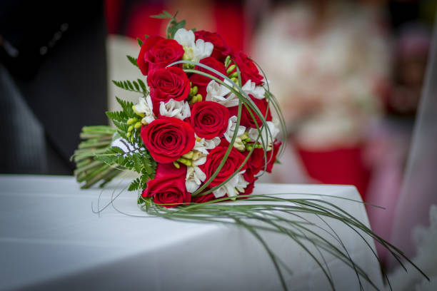 istock Wedding bouquet with red roses on the table 1437638375