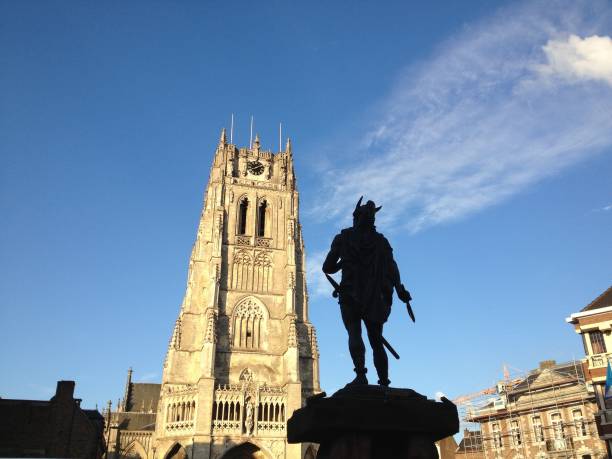 Tongeren, Belgium – August 23, 2013: Photo of the statue of Ambiorix with in front of him the basilica our lady of Tongeren in Belgium