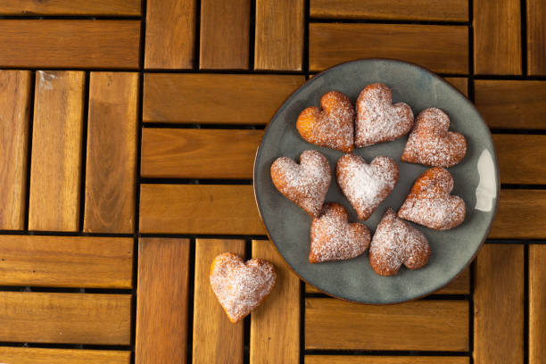 istock Heart shaped donuts on wooden table 1437639603