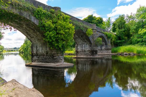 istock View of an old arc bridge with its reflection on the river 1437639749