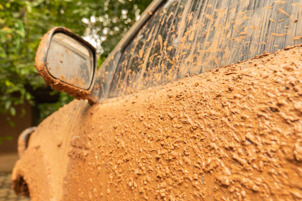 Dirty mud on the side of car, off-road on adventure,dangerous road trip activity.