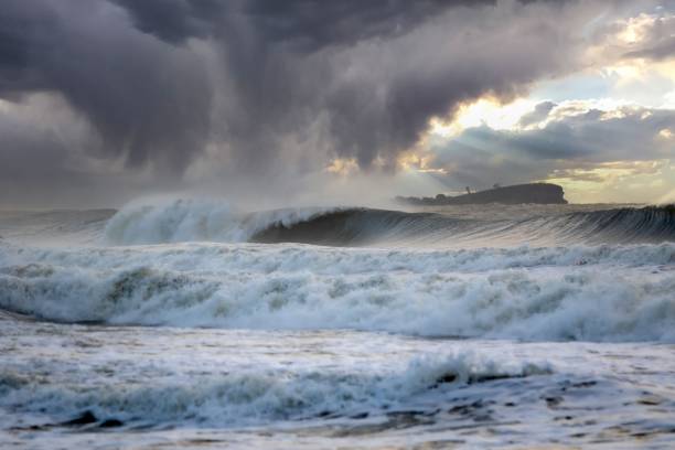 istock Wavy ocean shore during the storm with a cumulonimbus cloud hanging over the surface 1437641448