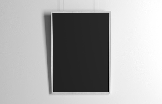 Blank poster template isolated on white wall with soft shadow