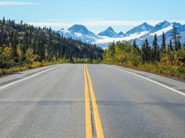 Asphalt road with yellow lines and the Worthington Glacier in Alaska in the background An asphalt road with yellow lines and the Worthington Glacier in Alaska in the background Worthington stock pictures, royalty-free photos & images