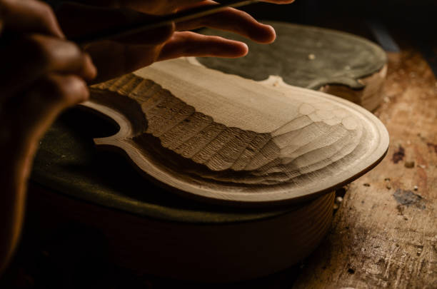 istock Artisan woman violin maker luthier working in a new violin 1437643308