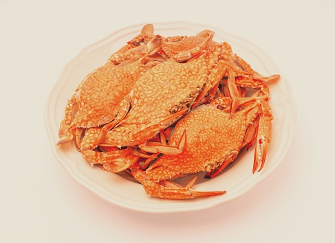 A pile of fresh crab legs on a white background.