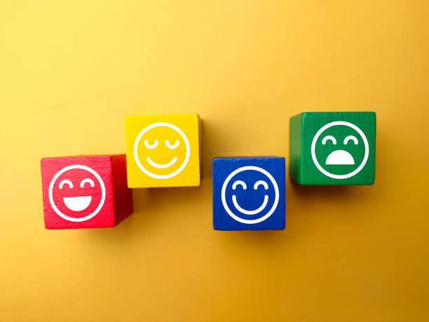istock Colored wooden block with happy and unhappy expression. Positive and negative concept. 1437643695