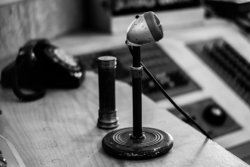A grayscale shot of vintage old school microphone