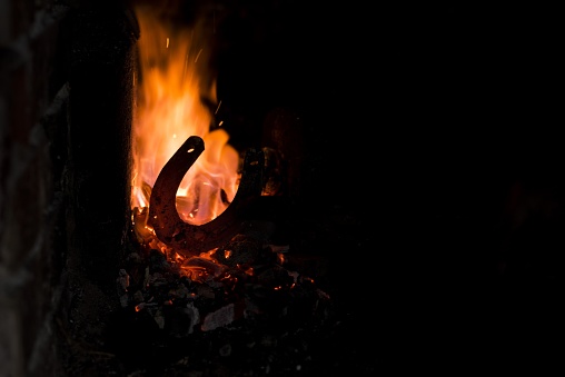 A closeup shot of a hot horseshoe in fire