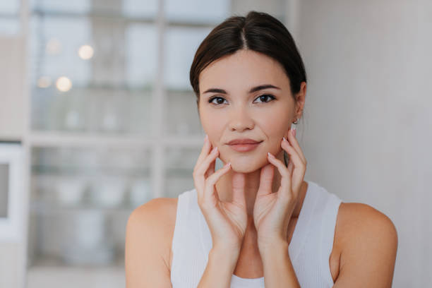 istock Gorgeous Aslan model touching face after skincare procedure looking at camera. Close up portrait of Korean woman at home relaxing. Skincare and cosmetics. Beauty and healthy lifestyle. 1437643974