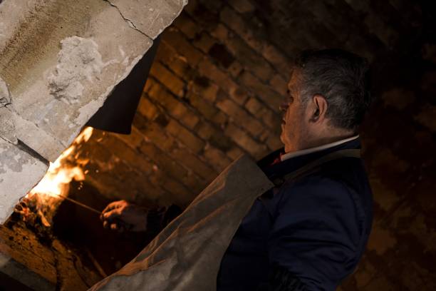 istock Dutch angle shot of an aged blacksmith near a fire 1437643999