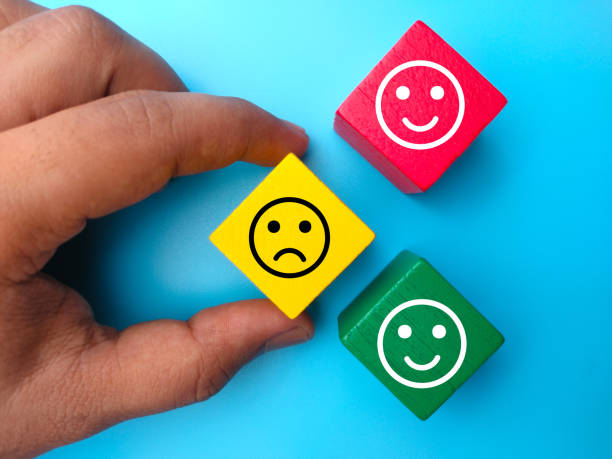 istock Hand holding colored wooden cube with expression unhappy and happy. Positive and negative person concept. 1437644272