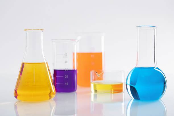 istock Group of different flasks with colorful liquids on a white background in a lab 1437644537