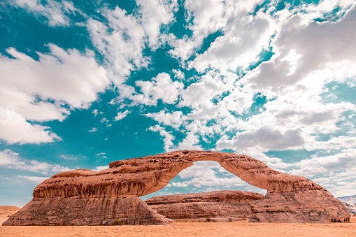 The beautiful Rainbow Rock on a sunny day under the beautiful sky filled with clouds in AlUla, Saudi Arabia