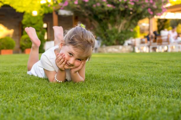 Mother and baby girl play in back yard, Lugano, Ticino