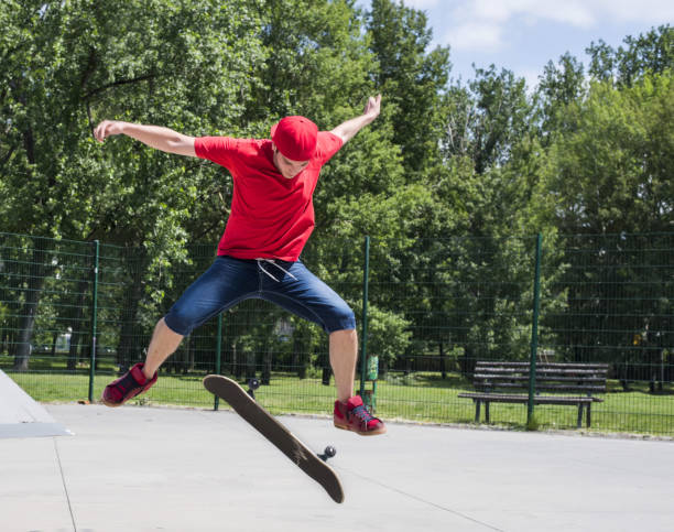 istock Young male doing tricks with a skateboard at a park 1437646086
