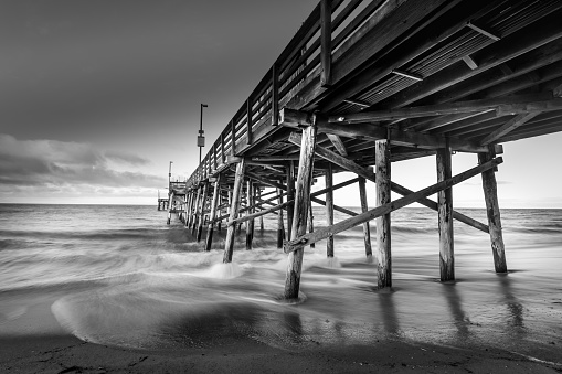 A long exposure shot of a pier on the beach in California