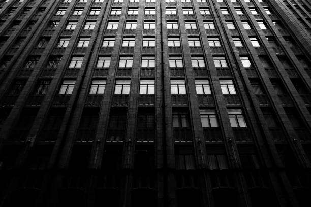 istock Grayscale low angle shot of wide apartment building 1437646580