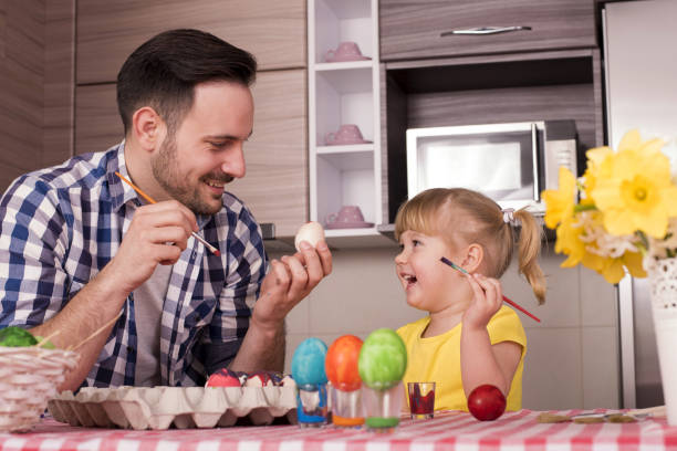 istock Father and his little child  painting the easter eggs 1437646814