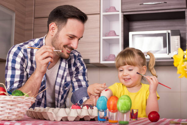 istock Father and his little child  painting the easter eggs 1437646859