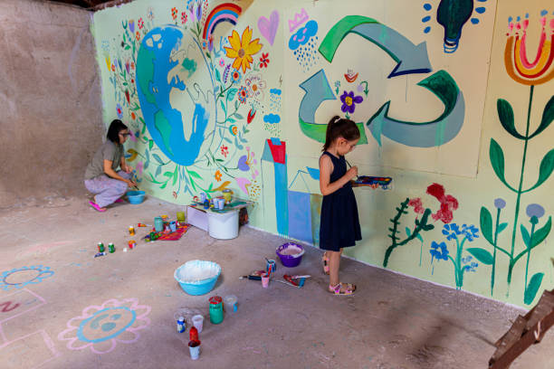istock Daughter and mother creating a mural. Planet Earth concept. 1437647060