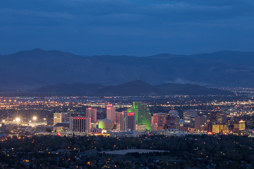 Reno, Nevada, United States – April 27, 2018: The colorful skyline of downtown Reno stretches across a background of mountains.
