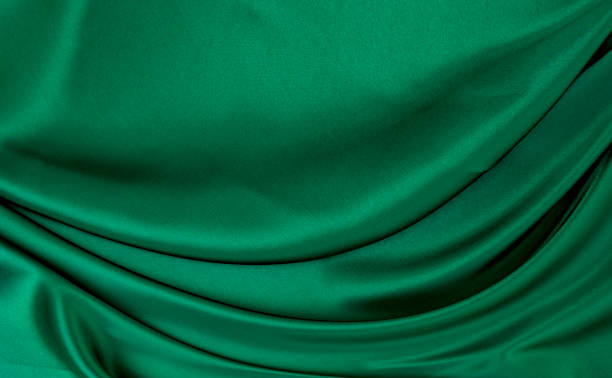 istock Green gray satin dark fabric texture luxurious shiny that is abstract silk cloth background with patterns soft waves blur beautiful. 1437648387